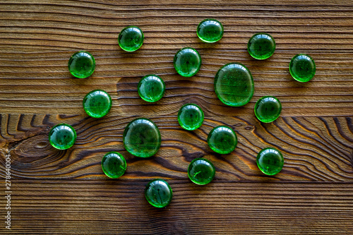 Bright stones on wooden background top view