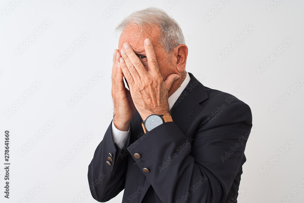 Senior grey-haired businessman wearing suit standing over isolated white background with sad expression covering face with hands while crying. Depression concept. Senior grey-haired businessman wearing suit standing over isolated white background with sad expression covering face with hands while crying. Depression concept.