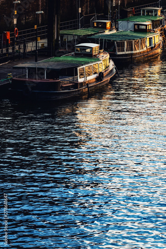 Old barges in the port of Hamburg. Dusk. Vertical. photo