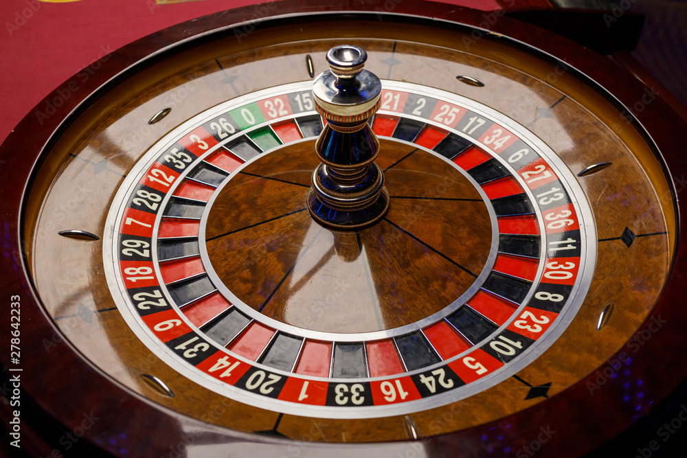 large wooden glossy poker roulette in a casino large wooden glossy poker roulette in a casino