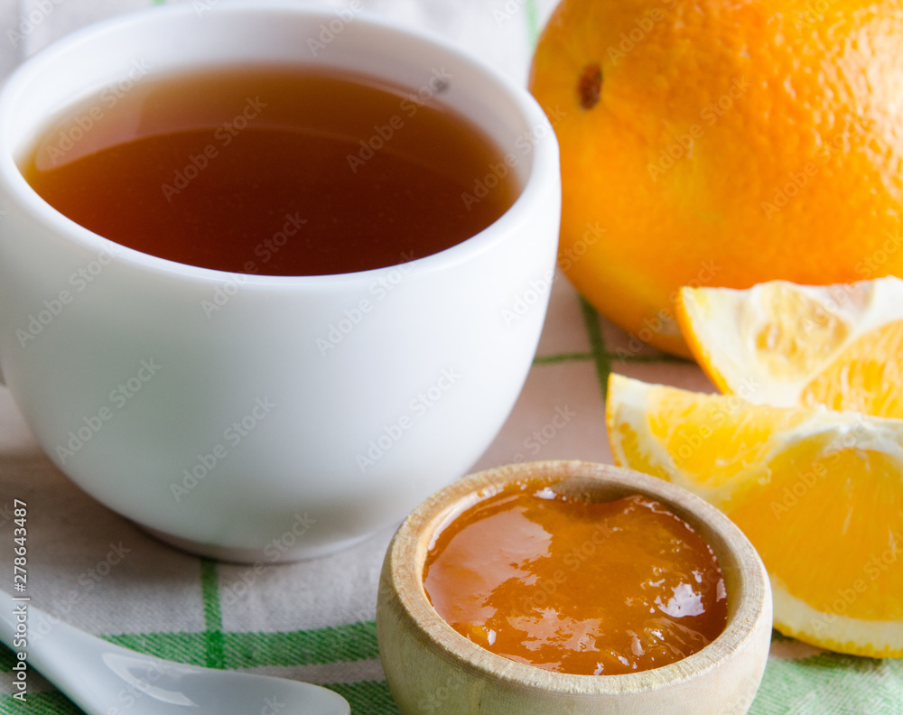 Cup of tea served with orange jam Cup of tea served with orange jam