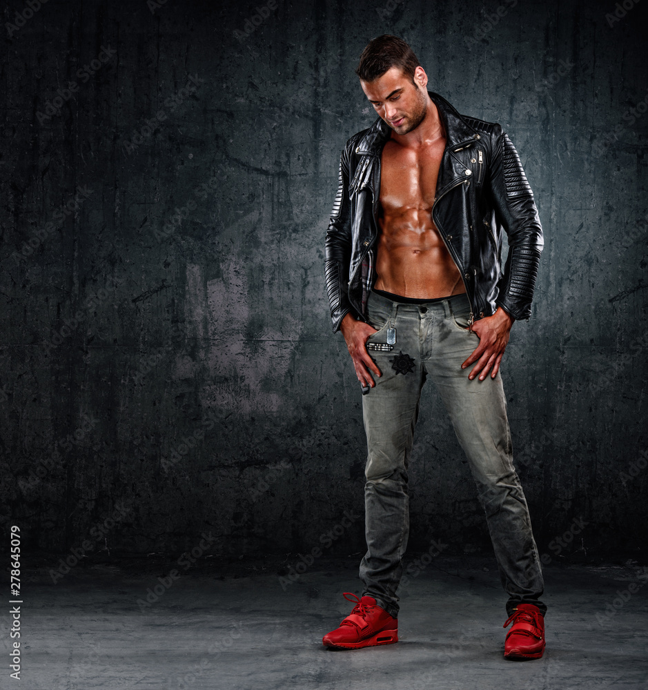 Handsome Athletic Male Fashion Model in Leather Jacket and Jeans Stock  Photo | Adobe Stock