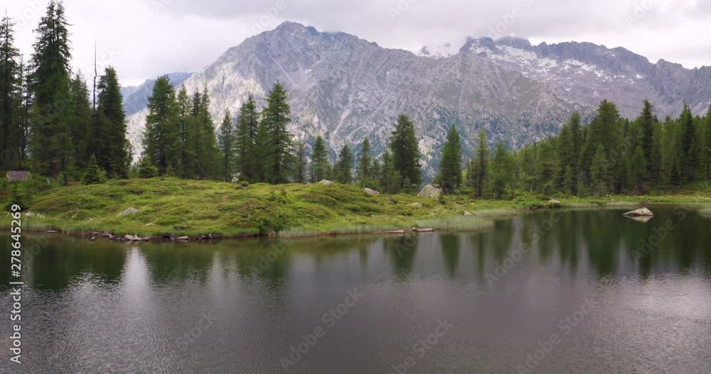 Aerial shot of an lake of mountains surrounded by nature in a magical, relaxing and green place. Aerial shot of an lake of mountains surrounded by nature in a magical, relaxing and green place.