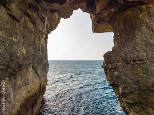 Natural arch over the sea. Wied il-Mielah canyon. Gozo, Malta photo