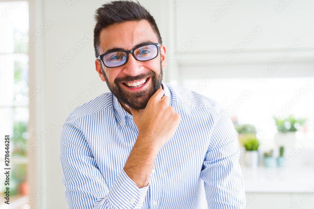 Handsome business man wearing glasses and smiling cheerful with confident smile on face Handsome business man wearing glasses and smiling cheerful with confident smile on face