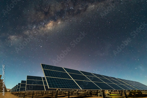 Solar Energy Panels view, a nice technology blue pattern at Atacama Desert arid lands. The solar modules going to the infinity with the Milky Way trying to get energy from the stars on the night sky 