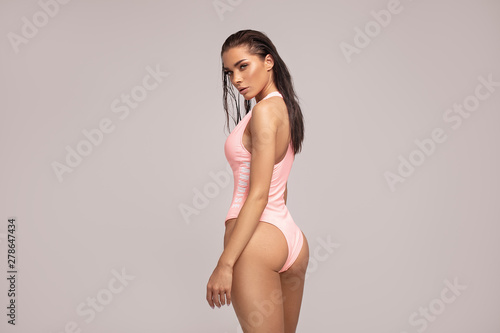 Fotografie Sexy woman in pink swimwear posing.