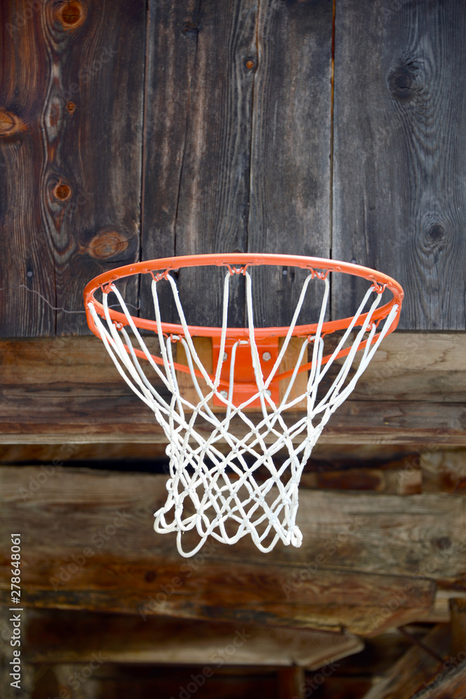 basketball hoop mounted on old wooden facade