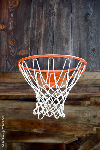 basketball hoop mounted on old wooden facade © mikesch112