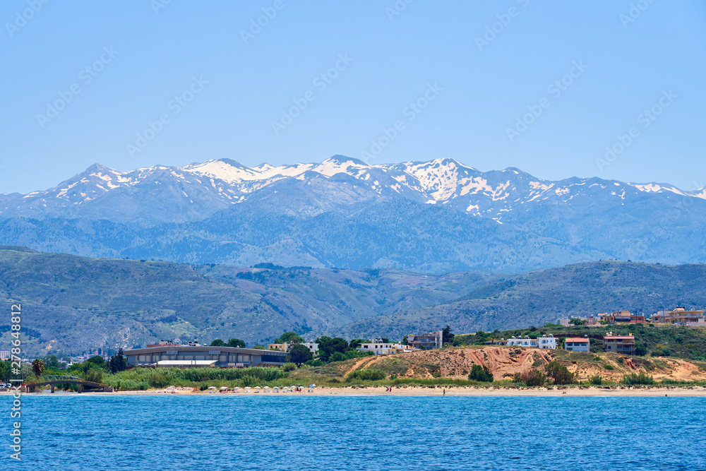 Sea coast of Chania, Crete, Greece with mountains and clear blue sky on a background.