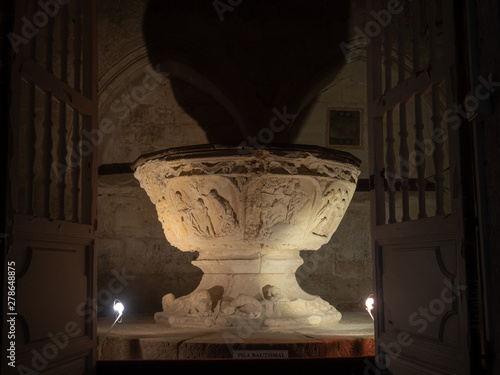 Romanesque baptismal font in the collegiate church of Santa Maria la Real in the village os Sasamon, Camino de Santiago in Spain. photo