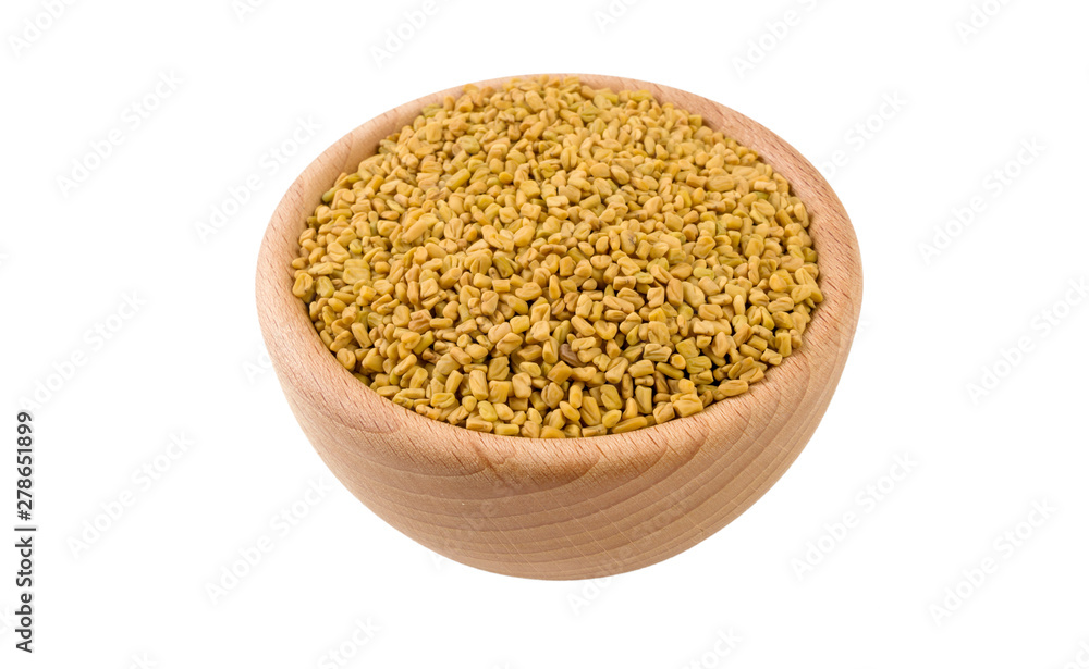 fenugreek seeds in wooden bowl isolated on white background. 45 degree view. Spices and food ingredients. fenugreek seeds in wooden bowl isolated on white background. 45 degree view. Spices and food ingredients.