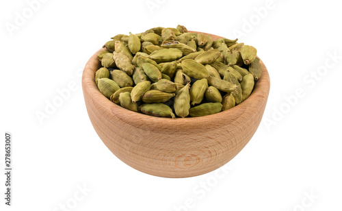 cardamon seeds in wooden bowl isolated on white background. 45 degree view. Spices and food ingredients.
