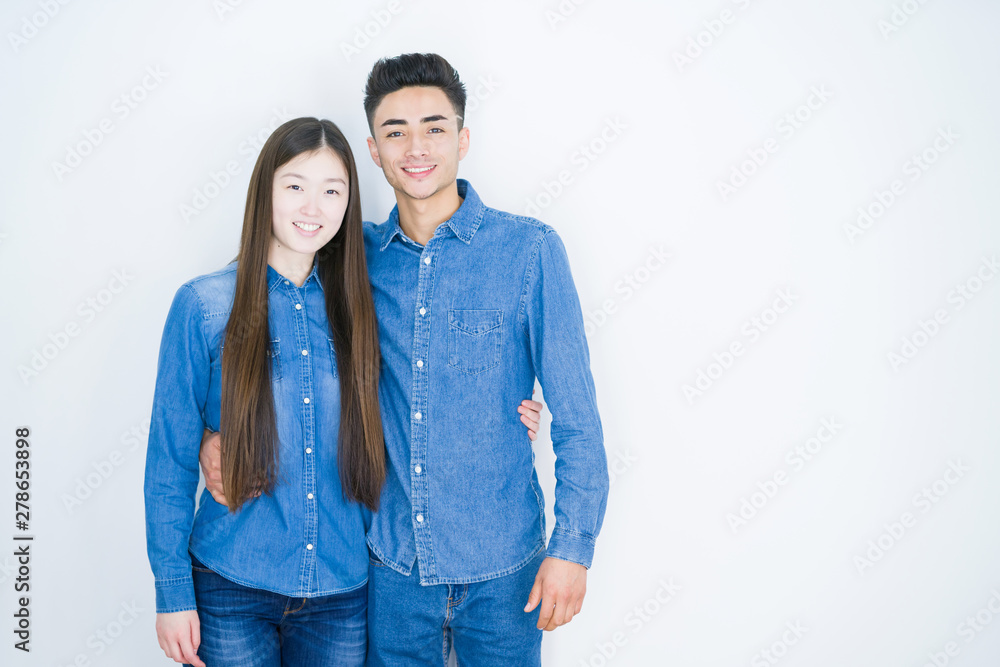 Beautiful young asian couple over white isolated background with a happy and cool smile on face. Lucky person. Beautiful young asian couple over white isolated background with a happy and cool smile on face. Lucky person.