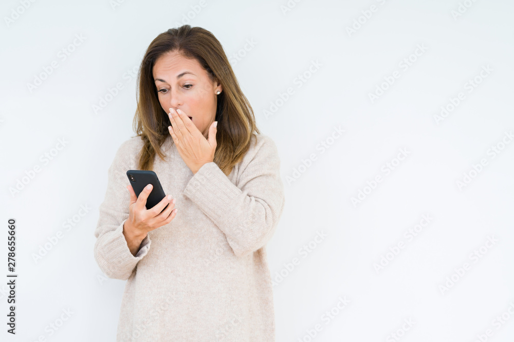 Middle age woman using smartphone over isolated background cover mouth with hand shocked with shame for mistake, expression of fear, scared in silence, secret concept Middle age woman using smartphone over isolated background cover mouth with hand shocked with shame for mistake, expression of fear, scared in silence, secret concept