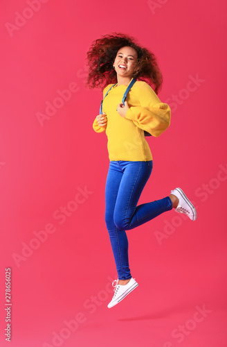 Jumping young woman on colo...