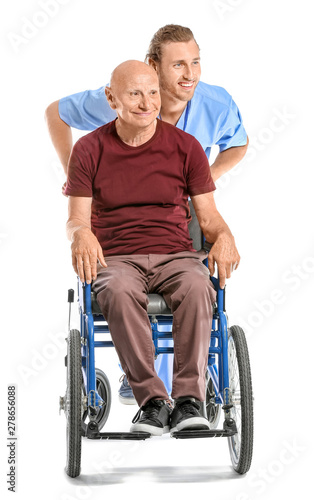 Handicapped elderly man with caregiver on white background