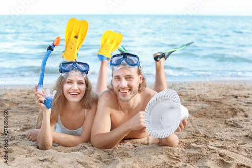 Happy young couple on beach...