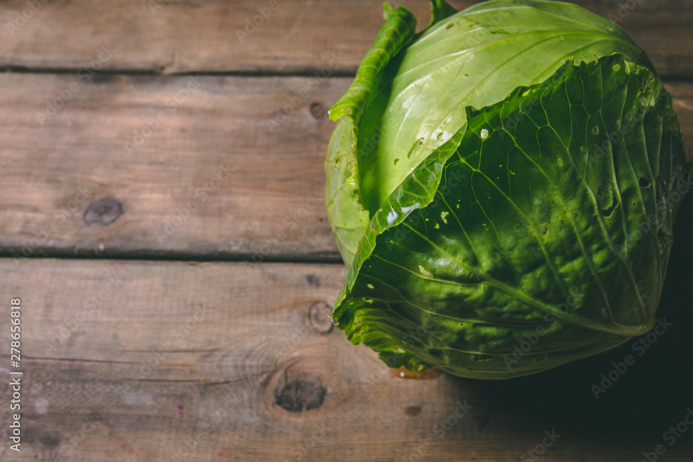 Fresh Cabbage on a wooden rustic table. Copy space. Healthy food. Raw Vegetables. Fresh Cabbage on a wooden rustic table. Copy space. Healthy food. Raw Vegetables.