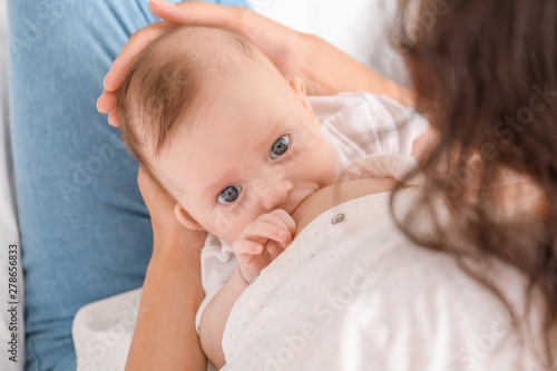 Young woman breastfeeding h...