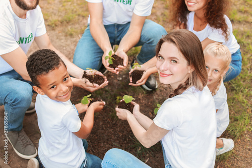 Volunteers with young plant...
