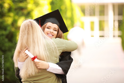 Happy mother greeting her daughter on graduation day