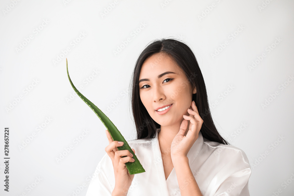 Beautiful Asian woman with aloe vera on white background Beautiful Asian woman with aloe vera on white background