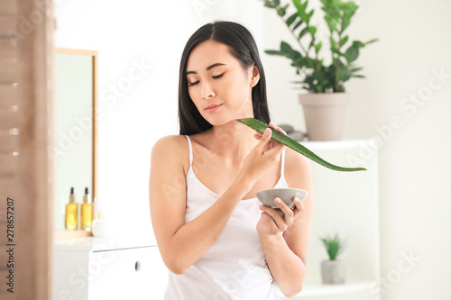 Beautiful Asian woman using...
