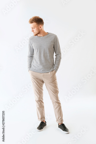 Stylish young man on white background © Pixel-Shot