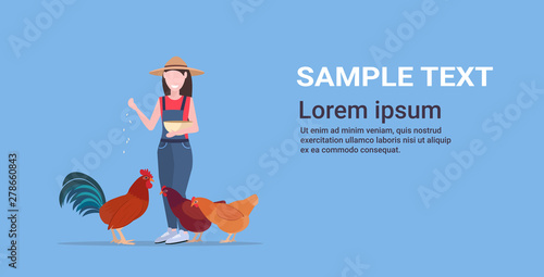 woman farmer feeding chicken and rooster poultry breeding farming agriculture concept girl in hat and robe holding tray with wheat flat full length horizontal copy space