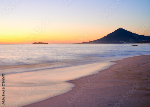 Sunset at the Moledo beach, with a mountain on backgroud