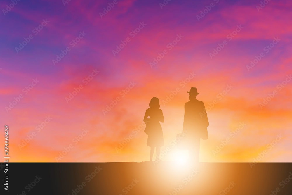 Silhouette of businessman and his wife evening sunset background
