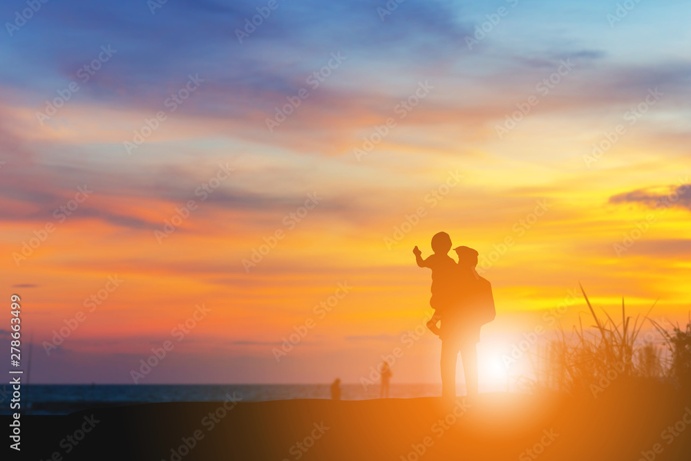 Silhouette of Grandfather and grandchild looking sun down and walking on the beach evening sunset background, Happy family concept