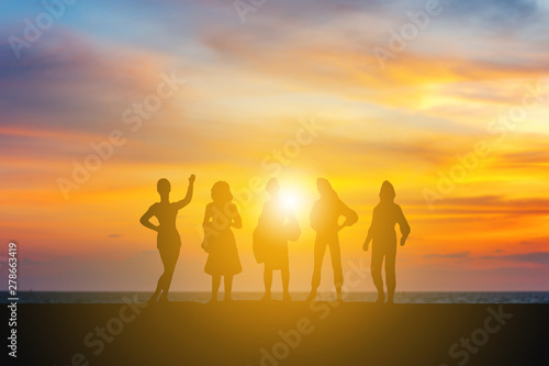Silhouette of Happiness women team with sunset evening sky background © JU.STOCKER