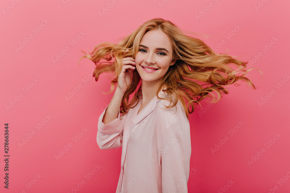 Fascinating pale woman in light-pink pyjama expressing happiness. Studio shot of lovable lady in cute night-suit laughing on bright background. Fascinating pale woman in light-pink pyjama expressing happiness. Studio shot of lovable lady in cute night-suit laughing on bright background.