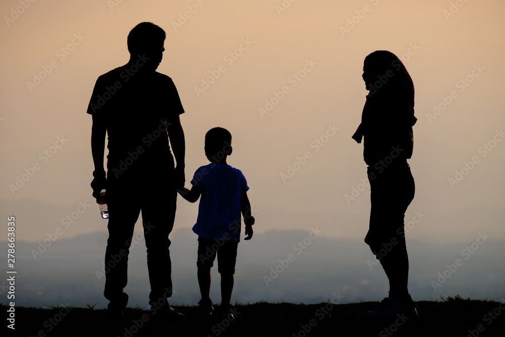 Silhouette happy  tourist family on the view point at sunset time.