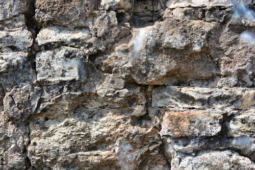 Masonry stone wall in the ancient city of side in Turkey. Natural stone background