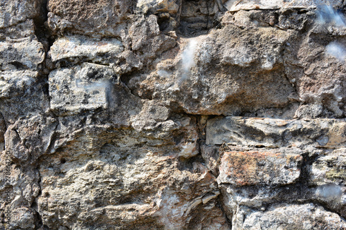 Masonry stone wall in the a...