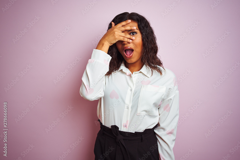 Transsexual transgender businesswoman standing over isolated pink background peeking in shock covering face and eyes with hand, looking through fingers with embarrassed expression. Transsexual transgender businesswoman standing over isolated pink background peeking in shock covering face and eyes with hand, looking through fingers with embarrassed expression.