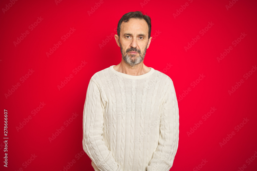 Handsome middle age senior man with grey hair over isolated red background Relaxed with serious expression on face. Simple and natural looking at the camera. Handsome middle age senior man with grey hair over isolated red background Relaxed with serious expression on face. Simple and natural looking at the camera.