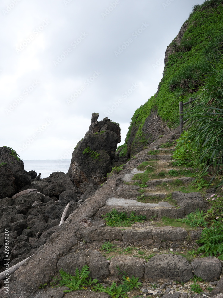 Irabu island,Japan-June 27, 2019: Path to Sabautsuga, the only well at the east of Irabu island. People used to go down 124 stone steps.