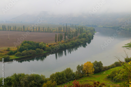 Fototapeta Naklejka Na Ścianę i Meble -  View of the Dniester river covered with a thick morning mist in autumn time