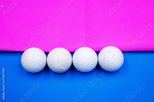 Golf ball on pink background