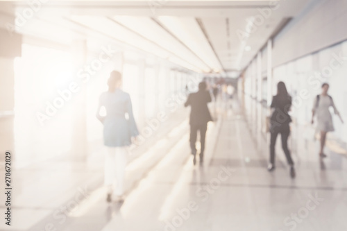Blurred background of businesspeople walking in the corridor of an business center