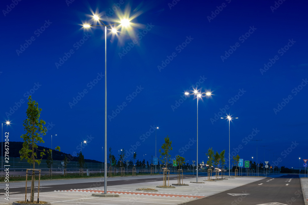 big modern empty parking lot with modern bright LED street lights