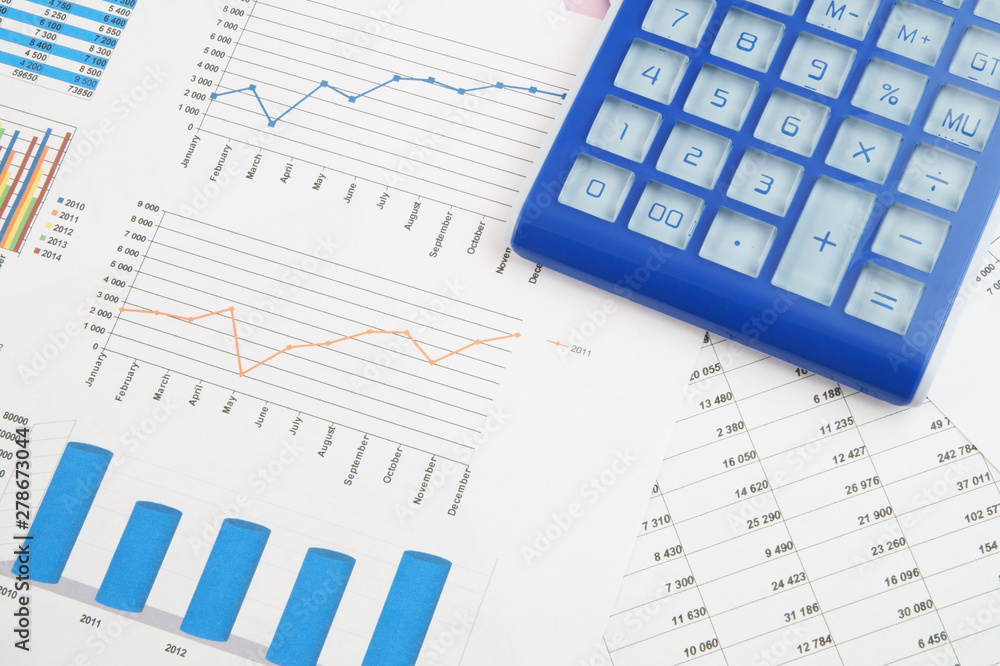 Business concept, calculator on financial charts and graphs Business concept, calculator on financial charts and graphs