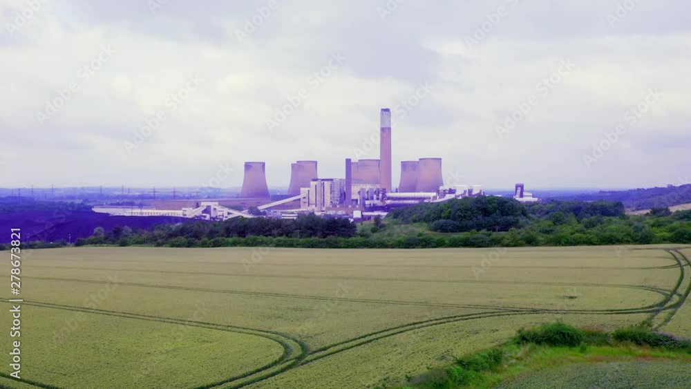 Low-level aerial of Power Station as a point of interest with a left to right panning Low-level aerial of Power Station as a point of interest with a left to right panning