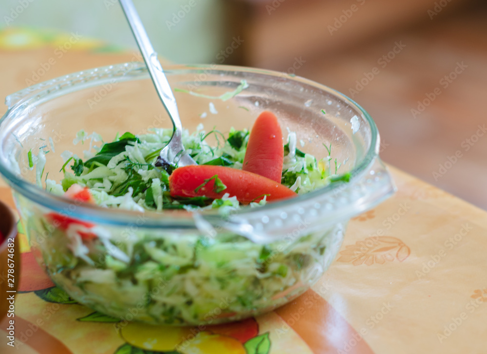 vegetable salad in a plate with a fork on the table