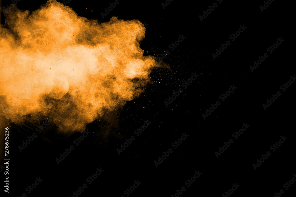 Abstract orange dust explosion on  black background.  Freeze motion of orange powder clouds splash.