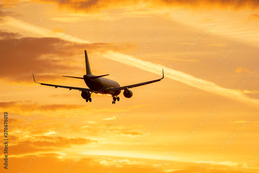 The plane flies in the sky at sunset The plane flies in the sky at sunset